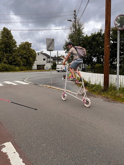 Man on a tall cycling contraption.