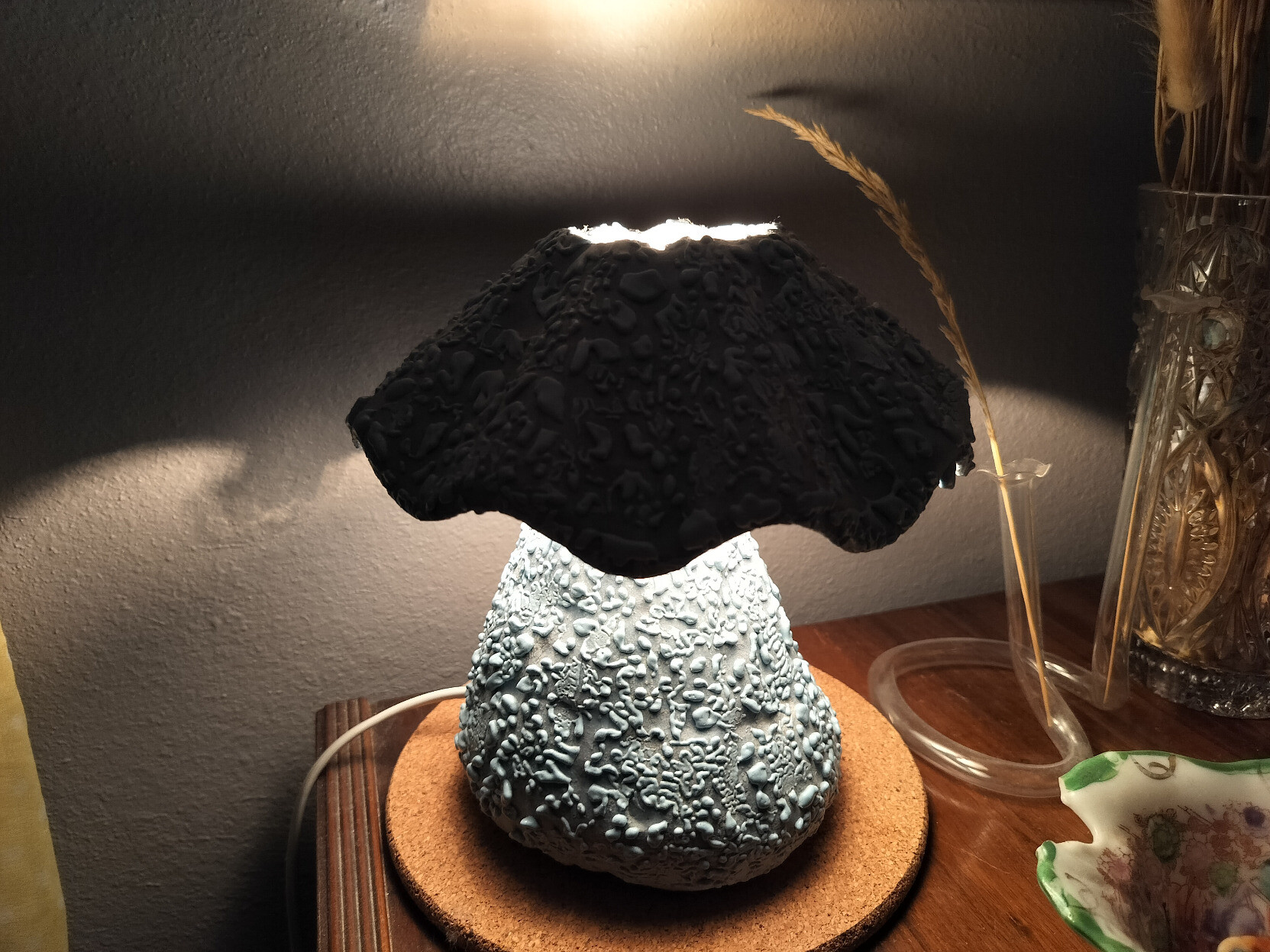 a powder blue handbuilt mushroom lamp with gloopy rough texture on surface